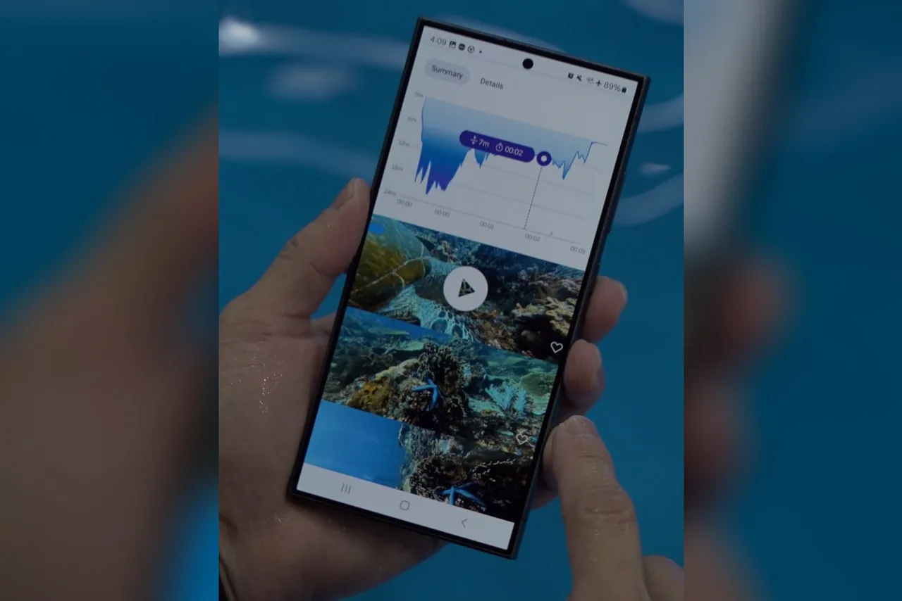 Celular exibindo o logbook do app DIVEROID com gráfico de profundidade e fotos do mergulho